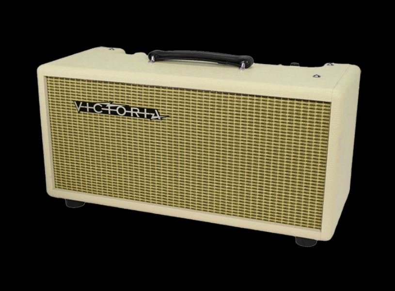 A cream-colored Victoria Reverb unit with a gold grille and a black carrying handle, shown against a solid black background.